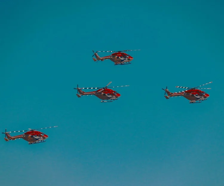 Formation of Black Hawk helicopters against a clear blue sky