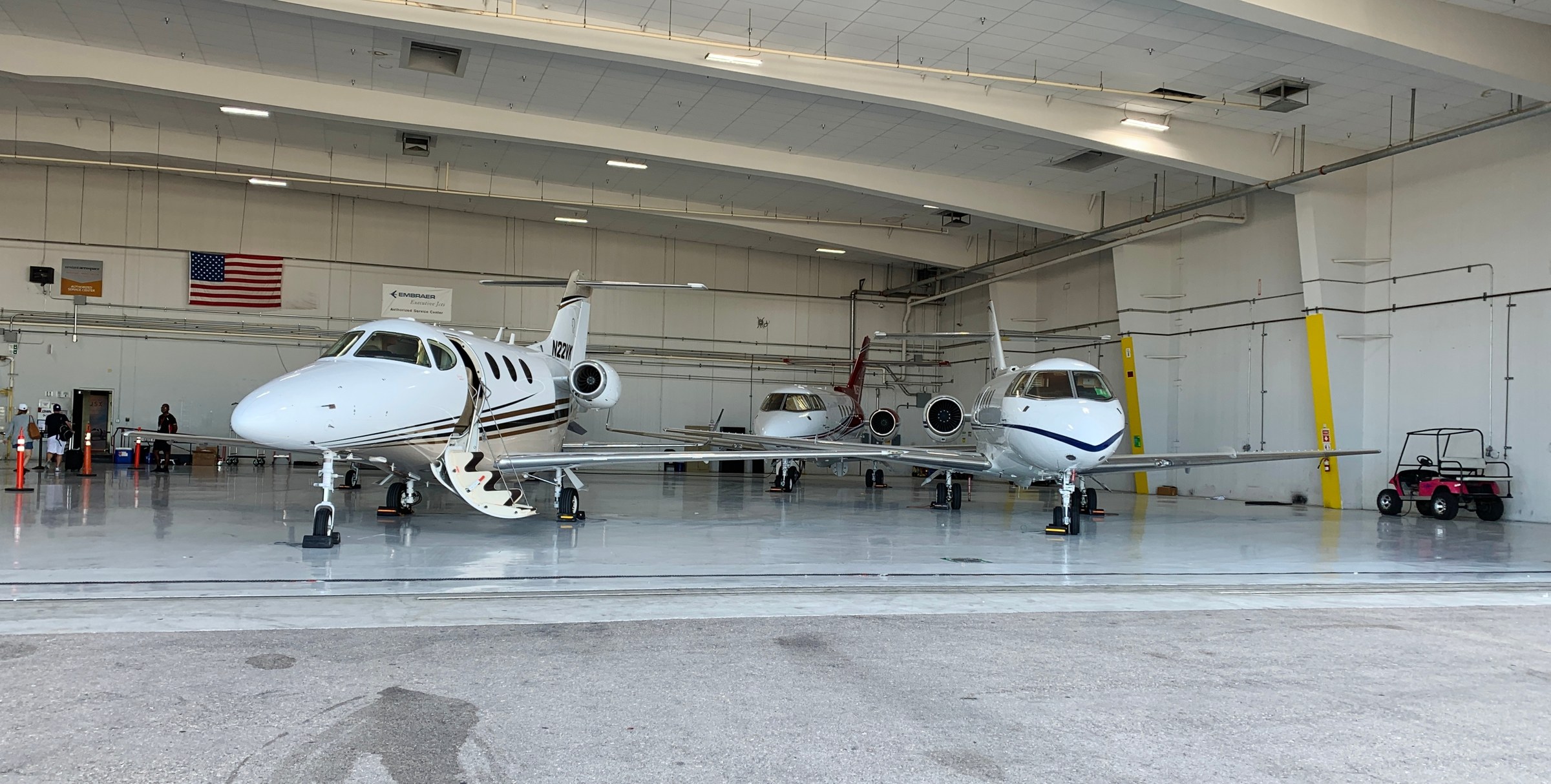 Private jets parked inside a service hangar